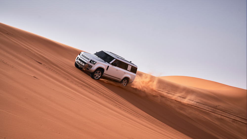 A 2023 Land Rover Defender 130 tackles the dunes of Dubai.