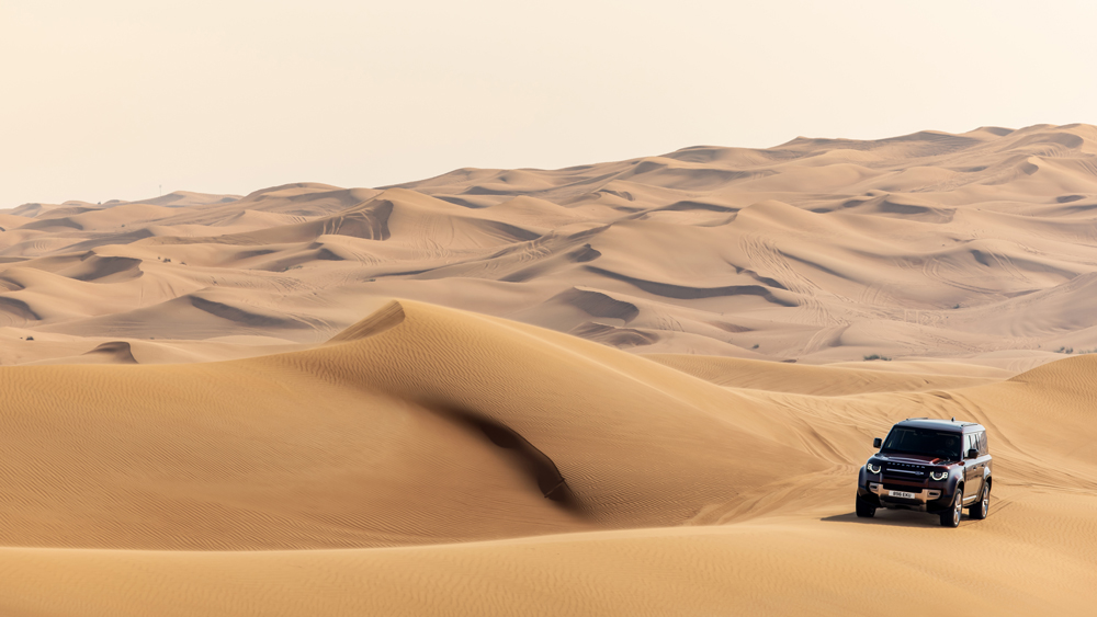 A 2023 Land Rover Defender 130 tackles the dunes of Dubai.